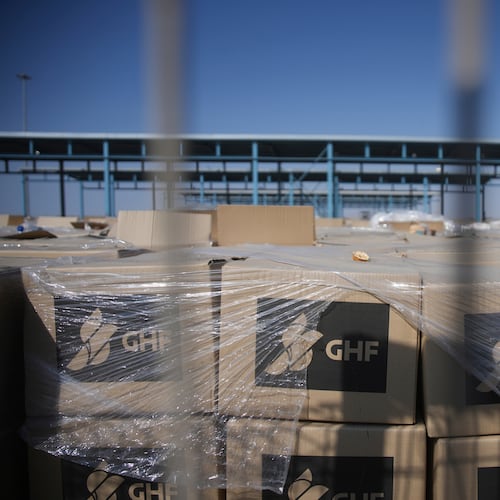 FILE - Piles of humanitarian aid packages from GHFwas, Gaza Humanitarian Foundation, wait to be picked up on the Palestinian side of the Kerem Shalom crossing in the Gaza Strip, Thursday, July 24, 2025. during a media tour organized by the Israeli army. (AP Photo/Ohad Zwigenberg, file)