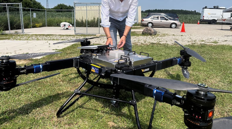 Volatus Aerospace COO Greg Colacitti inspects a heavy lift drone before a test run on July 13, 2026, in Kleinburg, Ontario. (AP Photo/Kelvin Chan)