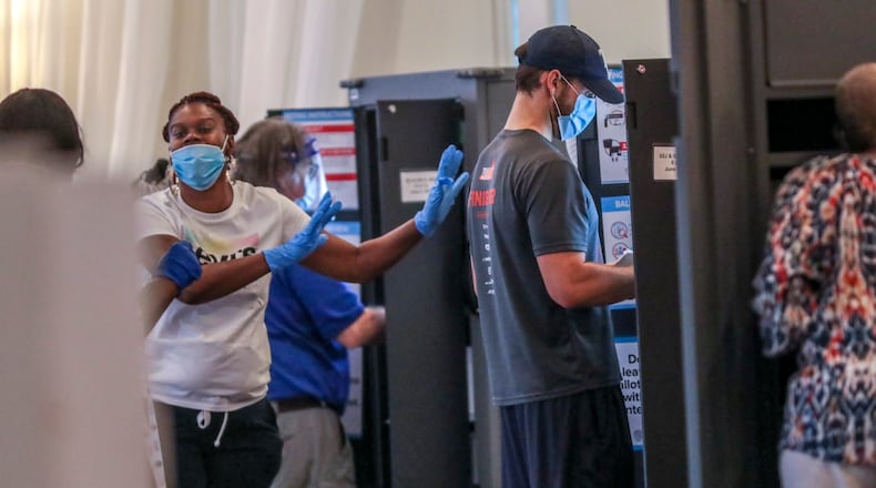 June 9, 2020 Atlanta: Poll workers respond to early glitches at the Park Tavern polling place located at 500 10th St NE, on Tuesday, June 9, 2020 in Atlanta. Many voters said they requested absentee ballots but never received them. Two lines, 300-yards long each formed parallel to Piedmont park in the parking lot as people patiently waited to vote. Over 1.2 million people had already voted before the polls opened on Tuesday, three-quarters of them with absentee-by-mail ballots, allowing them to avoid human contact at the polls. Voters will decide on many candidates, from president to county sheriff. The ballot also includes races for U.S. Senate, U.S. House and the Georgia General Assembly. JOHN SPINK/JSPINK@AJC.COM