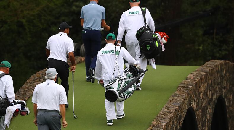 Fred Couples, Tiger Woods and Justin Thomas cross the Ben Hogan Bridge to the 12th green during their practice round for the Masters at Augusta National Golf Club on Wednesday, April 6, 2022, in Augusta, Georgia. (Curtis Compton/The Atlanta Journal-Constitution/TNS)