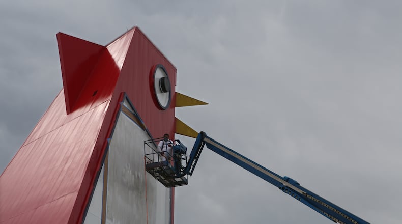 Marlon Ramirez operates the lift that keeps him positioned to paint on the side of the Big Chicken in Marietta, Georgia, on March 22, 2017. The local landmark that has been used for directions for decades is going under the first serious renovation in years.
