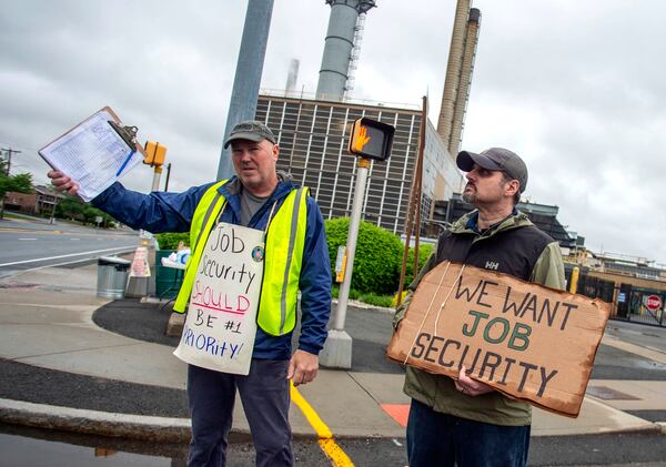 Pratt & Whitney employees hold signs while picketing at the Main Street entrance in East Hartford, Conn., on the first day of their strike, Monday, May 5, 2025. (Aaron Flaum/Hartford Courant via AP)