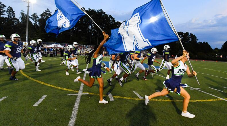 The Northview cheerleaders lead the team onto the field prior to a regular-season game at Johns Creek. (John Amis/Special)