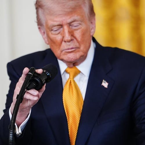 President Donald Trump adjusts his microphone while speaking during an event for military mothers in the East Room of the White House, Wednesday, May 6, 2026, in Washington. (AP Photo/Julia Demaree Nikhinson)