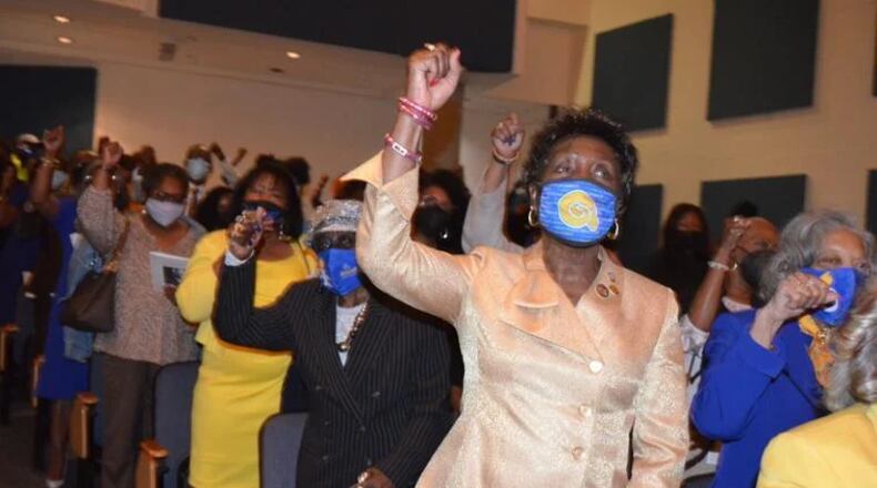 Audience members show their spirit during the singing of the Albany State University alma mater at the annual Founder's Day Convocation. (Courtesy of Alan Mauldin)