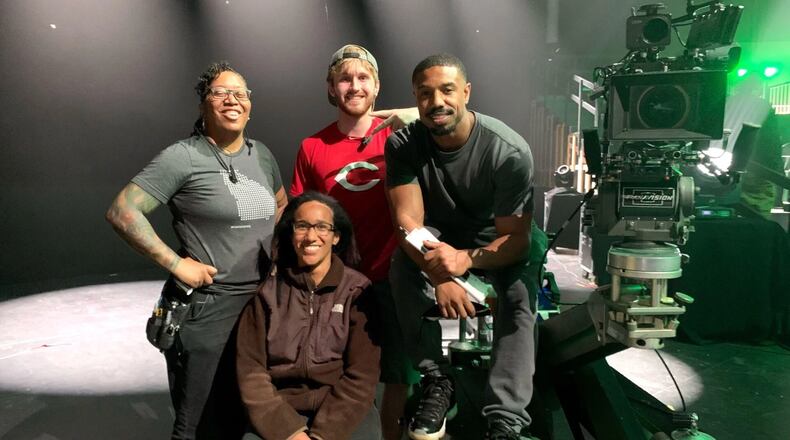 Gabrielle Dunnings (seated) on the set of "Creed III" with the movie's star, Michael B. Jordan, and other members of the crew. (Courtesy of Gabrielle Dunnings)