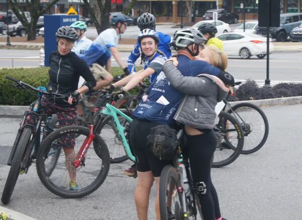 Jaiden Redcay greets her father, Jansenn Redcay, just after he arrived at City Springs on Dec. 10 at the end of his long ride. (Photo Courtesy of Bob Pepalis)