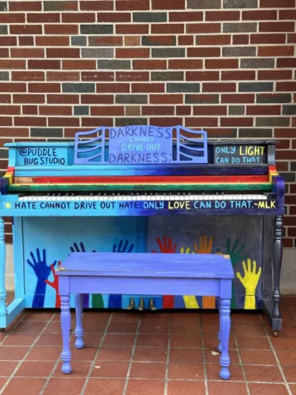 A multi-colored piano with a popular quote from civil rights leader Dr. Martin Luther King, Jr. sit outside the Virginia-Highland Church. “Hate cannot drive out hate, only love can do that.”