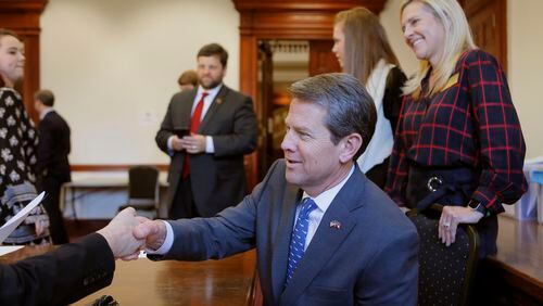Secretary of State Brian Kemp, accompanied by his wife, Marty (right), and daughter, Amy Porter, filed his qualification papers to run for governor on March 7, 2018.  BOB ANDRES  /BANDRES@AJC.COM