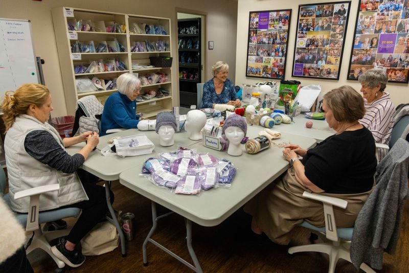 (l-r) Happy Cap volunteers Staci Lindfield, Helen Pumillo, Kathy DeJoseph, Paulette Smith & Sherry Engelken knit caps for cancer patients. Kathy DeJoseph, founder of Happy Caps, was touched when a woman made her a knit cap as she began chemo. PHIL SKINNER FOR THE ATLANTA JOURNAL-CONSTITUTION