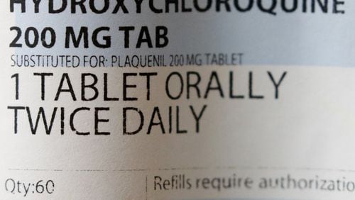 A label affixed to a bottle containing a prescription of hydroxychloroquine. President Donald Trump and his administration are promoting the anti-malaria drug not yet officially approved for fighting the new coronavirus, but scientists say more testing is needed before it’s proven safe and effective against COVID-19. (AP Photo/John Locher)