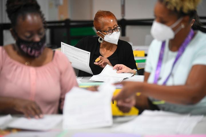 Election workers go through ballots as votes for President are recounted at the Gwinnett County elections office on Friday, Nov.13, 2020 in Lawrenceville. (JOHN AMIS FOR THE ATLANTA JOURNAL-CONSTITUTION)