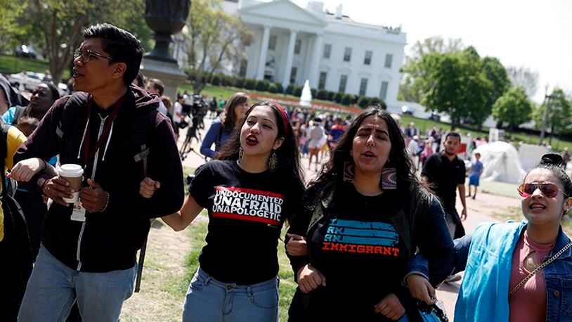 WASHINGTON, DC - APRIL 13: Demonstrators lock arms and chant during the "Stand Up to Trump" rally outside the White House April 13, 2017 in Washington, DC. Youth activists from around the country gathered to protest President Donald Trump's immigration policies.