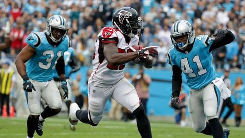 Falcons running back Tevin Coleman catches a touchdown pass in the fourth quarter Sunday against the Panthers in Bank of America Stadium in Charlotte, North Carolina.
