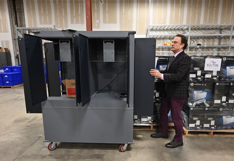Richard Barron, Director of Registration and Elections for Fulton County, shows the main unit of the new voting machine at Fulton County Election Preparation Center in Atlanta on Tuesday, Jan. 21, 2020. Truckloads of voting machines are arriving at a large Atlanta-area warehouse, where workers are unloading piles of cardboard boxes before a critical deadline: the March 24 presidential primary. (Hyosub Shin / Hyosub.Shin@ajc.com)