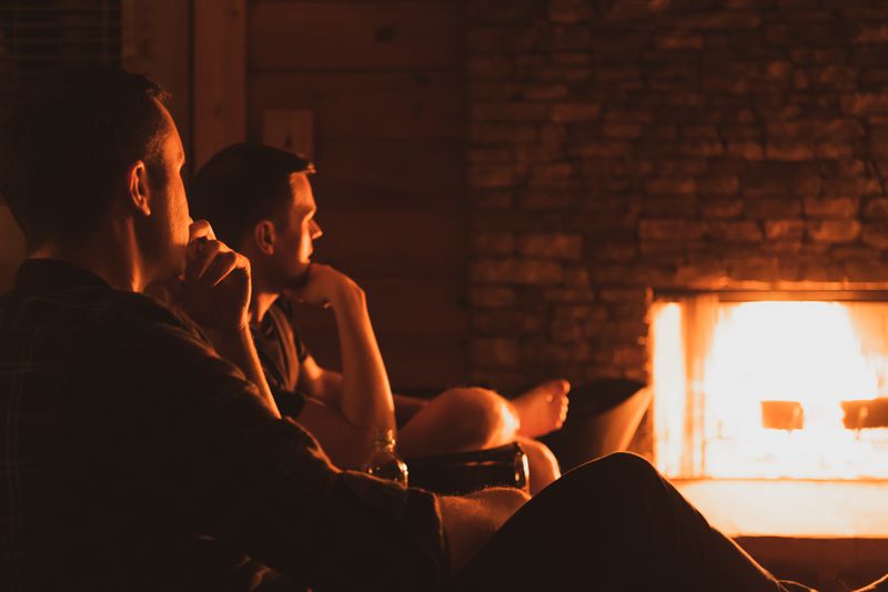 Davis Adams (left) and Baron Smith enjoy a quiet moment by the fireplace at their Lake Lanier home.