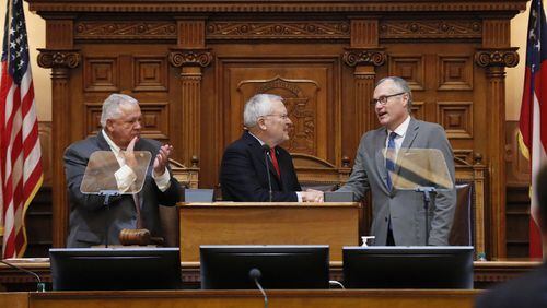 Gov. Nathan Deal, center, shakes hands with Lt. Gov. Casey Cagle as House Speaker David Ralston watches after the governor outlined his agenda in his final State of the State speech before a joint session of Georgia’s General Assembly. BOB ANDRES /BANDRES@AJC.COM