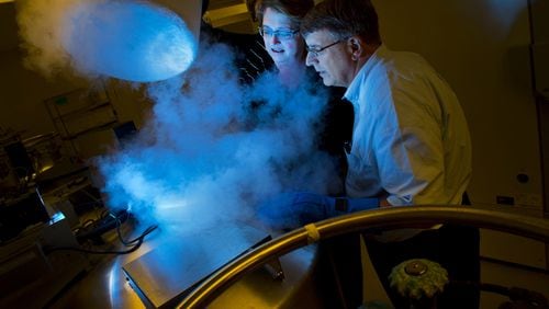 In this file photo, University of Miami medical researchers, from right, Dr. Jeffrey Vance and Dr. Margaret Pericak-Vance, peer into a tank of nitrogen where tissue used for DNA is stored at frigid temperatures. UM’s Miller School of Medicine is leading a group of four academic institutions in Florida and Georgia in an ambitious, five-year medical research effort aimed at making treatments and drugs more effective by tailoring them to the lifestyles, genetics and environment of individual patients. (Patrick Farrell/Miami Herald/TNS)