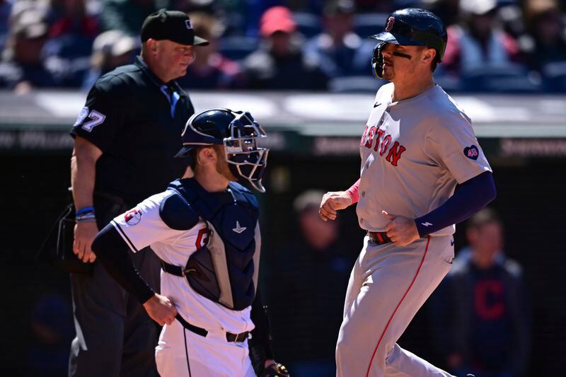 Boston Red Sox's Reese McGuire scores a run on an RBI-single by Jarren Duran during the sixth inning of a baseball game against the Cleveland Guardians, Thursday, April 25, 2024, in Cleveland. (AP Photo/David Dermer)