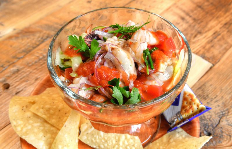 Vuelve a La Vida ceviche with poached shrimp and octopus, oysters, clams, tomato, clam juice, fish sauce, lime, valentina, green onion and cilantro. CONTRIBUTED BY CHRIS HUNT PHOTOGRAPHY