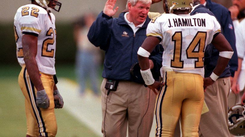 Georgia Tech coach George O'Leary talks with quarterback Joe Hamilton and wide receiver Dez White in the third quarter of the game between Georgia Tech and North Carolina at Bobby Dodd Stadium on Saturday, October 9, 1999. (LEVETTE BAGWELL/AJC File)