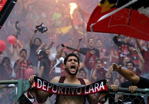 A fan of Venezuela's Deportivo Lara cheers his team during a Copa Libertadores soccer match against Argentina's Newell's in Barquisimeto, Venezuela.
