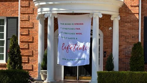 This banner was placed outside the Alpha Chi Omega sorority house at the University of Georgia, where Laken Hope Riley was a member. Riley, 22, was found dead in a wooded area on the UGA campus last Thursday. Riley attended UGA and transferred to the Augusta University nursing program in Athens. (Fletcher Page / fletecher.page@ajc.com)