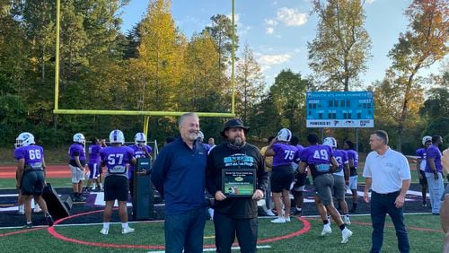 South Atlanta Hornets coach Brad Stephens (right) accepts the Georgia High School Football Daily Team of the Week award following their Oct. 9 win over then-No. 7 Pace Academy.