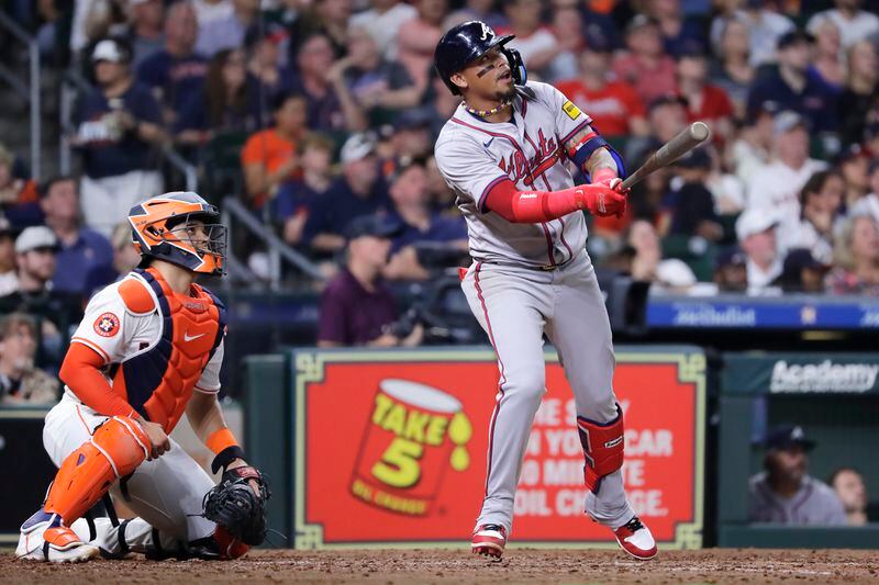 Atlanta Braves' Orlando Arcia, right, watches his sacrifice fly to center field next to Houston Astros catcher Yainer Diaz, left, scoring Austin Riley during the seventh inning of a baseball game Tuesday, April 16, 2024, in Houston. (AP Photo/Michael Wyke)