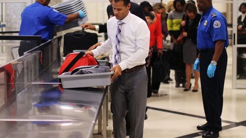 Nov. 23, 2015 - Atlanta - Airport employee Tony O'brien leads the line through security in a timed test to show how possession of prohibited items delays the line. TSA personnel demonstrated how they respond to prohibited items at security checkpoints in a session for the press using airport employees playing the part of passengers. The Transportation Security Administration is advising travelers to keep prohibited items out of their bags to keep security lines moving. At Hartsfield-Jackson Atlanta International Airport, more than 130 people have been caught with guns at airport security checkpoints so far this year. Whenever a gun, explosive or other dangerous weapons are caught at checkpoints, TSA officers halt security screening in the lane and call Atlanta police to respond to the checkpoint. BOB ANDRES / BANDRES@AJC.COM