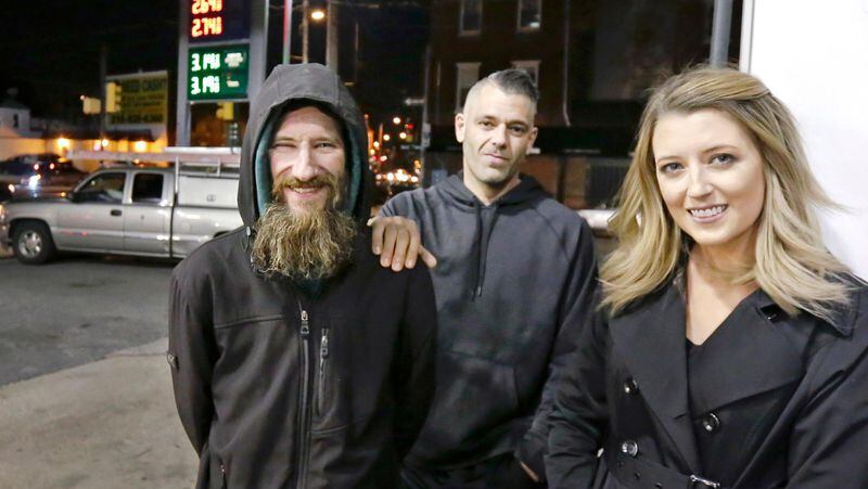 FILE- In this Nov. 17, 2017, photo, Johnny Bobbitt Jr., left, Kate McClure, right, and McClure's boyfriend Mark D'Amico pose at a Citgo station in Philadelphia. When McClure ran out of gas, Bobbitt, who is homeless, gave his last $20 to buy gas for her. McClure started a Gofundme.com campaign for Bobbitt that has raised nearly $400,000. (Elizabeth Robertson/The Philadelphia Inquirer via AP, File)