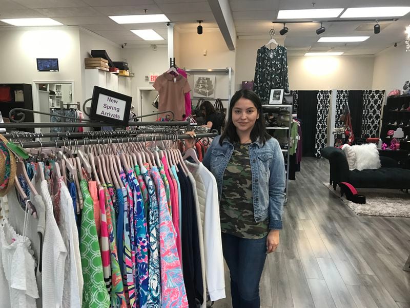 Paola Tapia, regional manager at Alexis Suitcase Upscale consignment store in Sandy Springs says business is great in the area.
