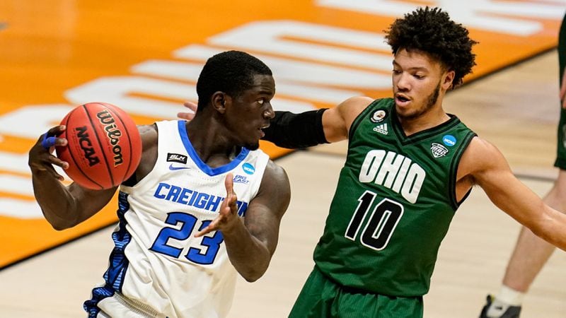 Creighton forward Damien Jefferson (23) drives Ohio guard Mark Sears (10) in the second half of a second-round game in the NCAA men's college basketball tournament at Hinkle Fieldhouse in Indianapolis, Monday, March 22, 2021. (AP Photo/Michael Conroy)