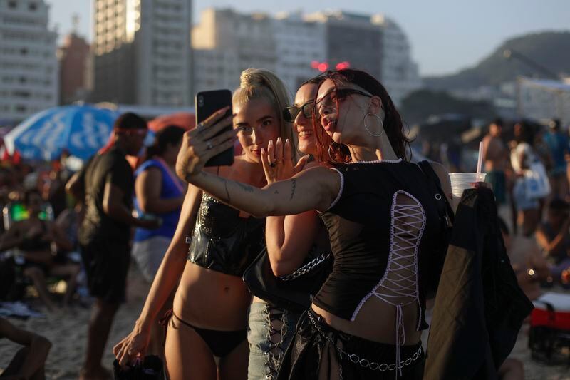 Fans take a selfie as they wait for the start of Madonna's last show of The Celebration Tour, on Copacabana beach in Rio de Janeiro, Brazil, Saturday, May 4, 2024. (AP Photo/Bruna Prado)