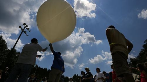 Georgia Tech professor Morris B. Cohen (right) looks on as engineering students prepare to launch a balloon to 100,000 feet. Cohen conducted an experiment during the 2017 total eclipse at a Rabun County summer camp called Ramah Darom. CURTIS COMPTON / CCOMPTON@AJC.COM