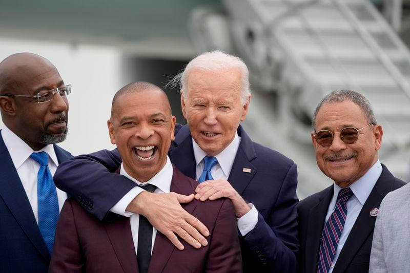 President Joe Biden, second from right, is greeted by alumni of Morehouse College in Atlanta on Saturday. From left to right: U.S. Sen. Raphael Warnock, D-Ga., Marlon Kimpson and U.S. Rep. Sanford Bishop, D-Albany. 
