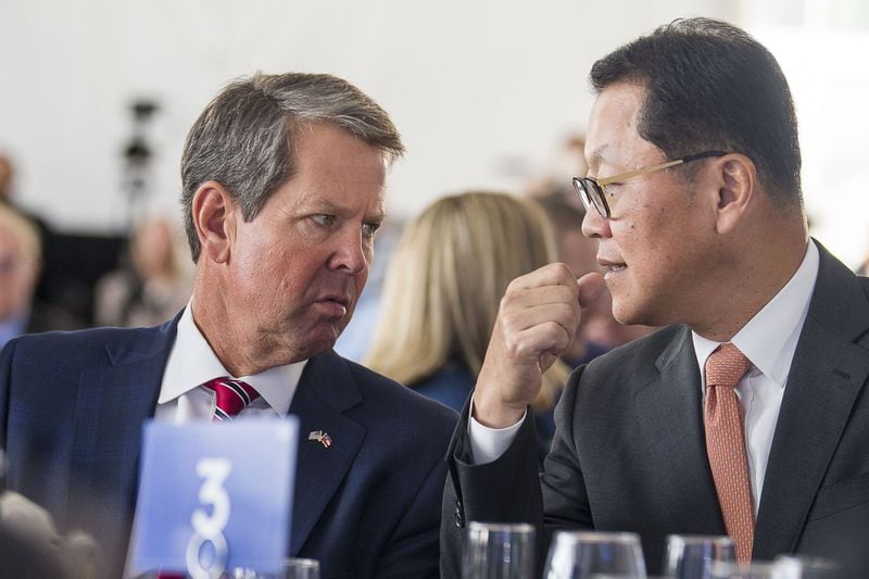 Dalton, Georgia — Gov. Brian Kemp (left) speaks with Hanwha Q Cells CEO Charles Kim during the grand opening of a Hanwha Q Cells solar manufacturing facility in Dalton. The plant started production earlier this year. (Alyssa Pointer/alyssa.pointer@ajc.com)
