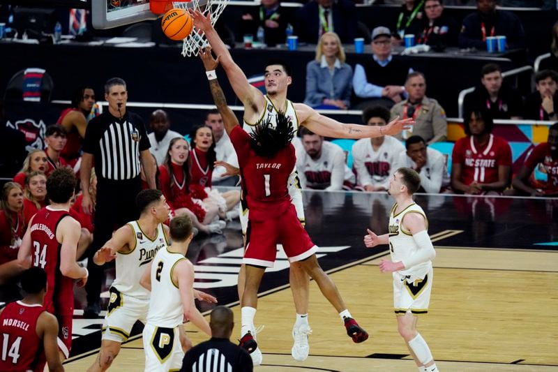 Purdue center Zach Edey blocks the shot of NC State guard Jayden Taylor (1) during the second half of the NCAA college basketball game at the Final Four, Saturday, April 6, 2024, in Glendale, Ariz. (AP Photo/Ross D. Franklin)