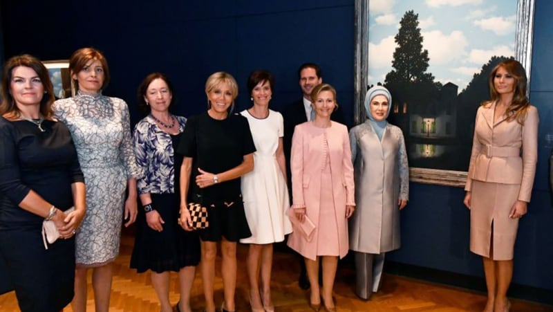 (L-R) First Lady of Iceland Thora Margret Baldvinsdottir, partner of Bulgaria's President Desislava Radeva, partner of NATO head Ingrid Schulerud, partner of France's president Brigitte Macron, partner Belgium's prime minister Amelie Derbaudrenghien, husband of Luxembourg's pime minister  Gauthier Destenay, partner of Slovenia's prime minister Mojca Stropnik, First Lady of Turkey Emine Gulbaran Erdogan, First Lady of the US Melania Trump and Chairman of the Royal Museums of Fine Arts of Belgium Michel Draguet  pose during a visit to the Magritte Museum, on May 25, 2017, in Brussels, on the sidelines of the NATO (North Atlantic Treaty Organization) summit. / AFP PHOTO / BELGA / ERIC LALMAND / Belgium OUT        (Photo credit should read ERIC LALMAND/AFP/Getty Images)