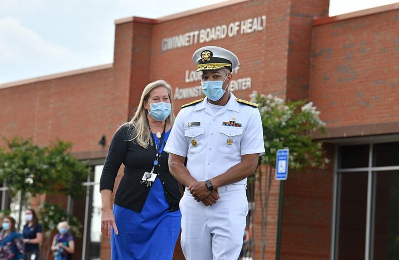 July 2, 2020 Lawrenceville - U.S. Surgeon General Jerome Adams (right) and Gwinnett Newton Rockdale Health Director Audrey Arona walk to the podium for a press conference amid a rise in coronavirus cases in Gwinnett County outside the Louise Radloff Administrative Building in Lawrenceville on Thursday, July 2, 2020. U.S. (Hyosub Shin / Hyosub.Shin@ajc.com)