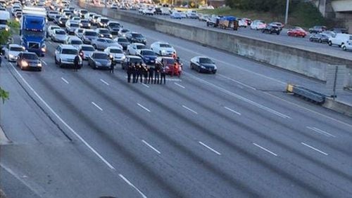 Protesters stand in the middle of I-75 northbound near Freedom Parkway. (Shelby Messing)