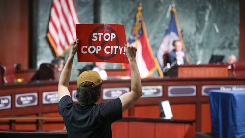 A protestor holds a “Stop Cop City,” sign to the Atlanta City Council during the public comment portion ahead of the final vote to approve legislation to fund the training center at Atlanta City Hall, on Monday, June 5, 2023, in Atlanta. (Jason Getz / Jason.Getz@ajc.com)
