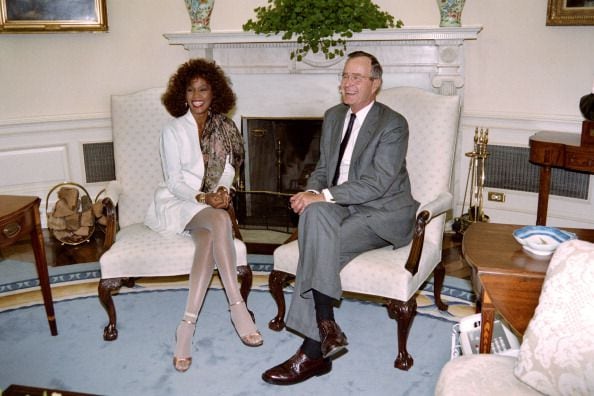 1990: Whitney Houston (L) posing with then US President George Bush