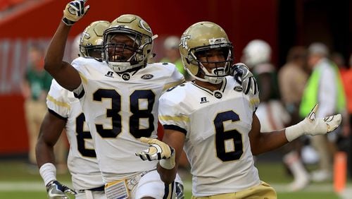 Lamont Simmons celebrates with Ajani Kerr after returning an onside kick for a touchdown to open the second half of Saturday's Georgia Tech-Miami game.  (Photo by Mike Ehrmann/Getty Images)