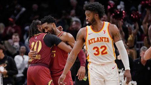 Cleveland Cavaliers' Donovan Mitchell, center, embraces teammate Darius Garland, left, behind Atlanta Hawks' Wesley Matthews (32) after the Cavaliers defeated the Hawks in an In-Season Tournament NBA basketball game, Tuesday, Nov. 28, 2023, in Cleveland. (AP Photo/Sue Ogrocki)