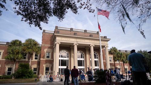 People gather outside the Glynn County Courthouse in Brunswick, Ga. on Monday, Nov. 22, 2021, as closing arguments are delivered in the murder of Ahmaud Arbery. Arbery, a 25-year-old Black man, was chased through a Brunswick, Ga., suburb and fatally shot at close range on Feb. 23, 2020. (Nicole Craine/The New York Times)