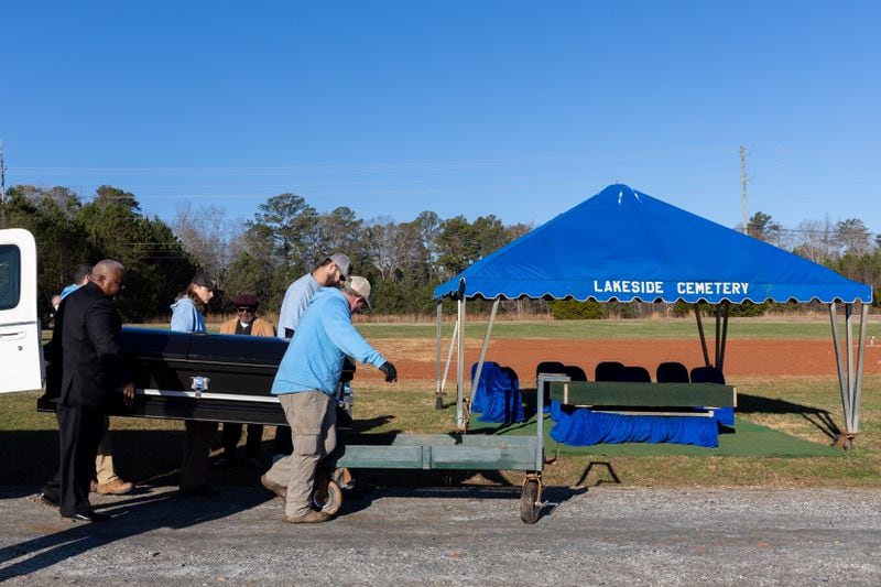Lakeside Cemetery employees bring a casket to be buried as part of the Fulton County indigent burial program at Lakeside Cemetery in Palmetto on Thursday, Dec. 28, 2023. (Arvin Temkar / arvin.temkar@ajc.com)