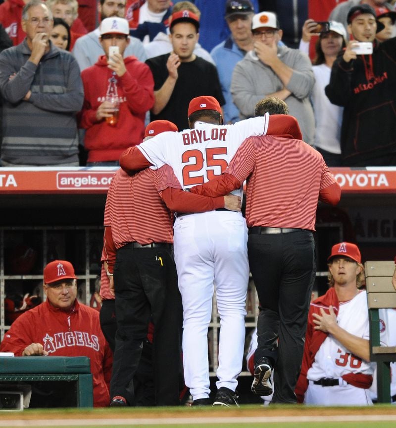 Los Angeles Angels batting coach Don Baylor injured his leg while catching the first pitch on Opening Day in Anaheim, Calif., Monday, March 31, 2014. (Wally Skalij/Los Angeles Times/MCT) Don Baylor is helped to the dugout. (Wally Skalij/L.A. Times - MCT)