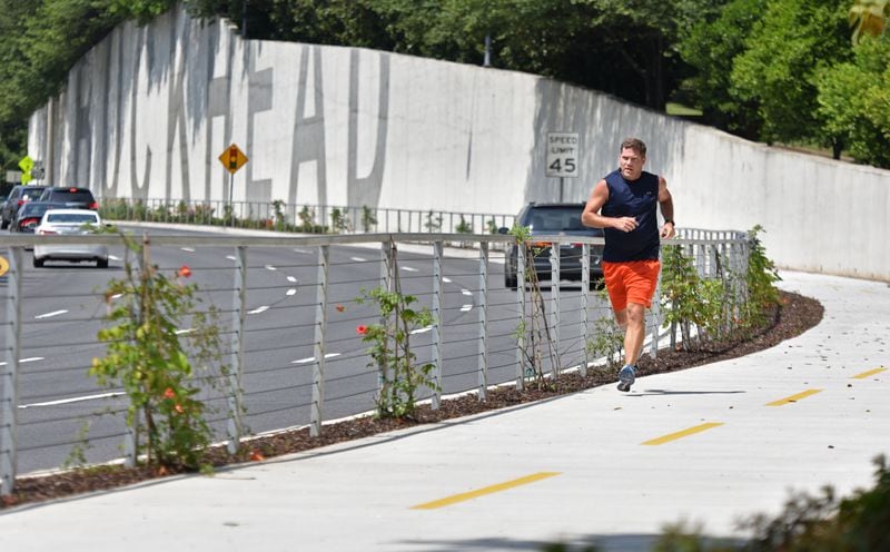 July 2, 2015, Atlanta -- Nick Huston, of Sandy Springs, who works in Buckhead, jogs on the phase 1 stretch of PATH400, which opened in January 2015. The half-mile stretch of multi-use path opened in January 2015. It connects Lenox Road at Tower Place with Old Ivy Road, where another extension north to Wieuca Road opened last year. HYOSUB SHIN / HSHIN@AJC.COM