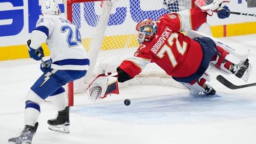 Florida Panthers goaltender Sergei Bobrovsky (72) blocks a shot by Tampa Bay Lightning defenseman Matt Dumba (24) during the second period of Game 2 of the first-round of an NHL Stanley Cup Playoff series, Tuesday, April 23, 2024, in Sunrise, Fla. (AP Photo/Wilfredo Lee)